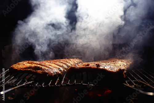 Fotografie, Obraz pork ribs on the grill cooking coals / fresh meat pork cooked on charcoal, summe