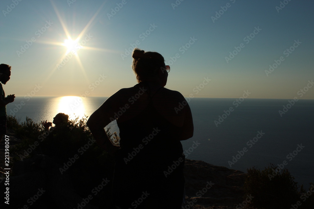 Woman silhouette at sunset in Ibiza