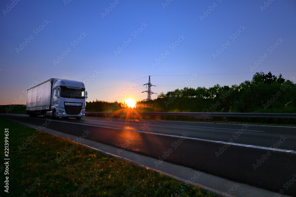 Truck transportation on the road at sunset