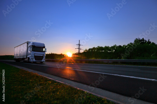 Truck transportation on the road at sunset