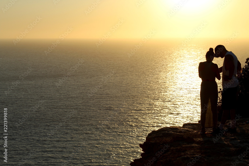 Sunset silhouettes during amazing golden sunset in Ibiza