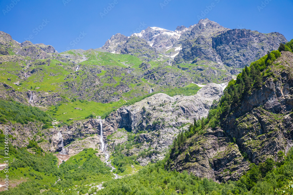 high waterfall  and mountain in sunny day aerial view