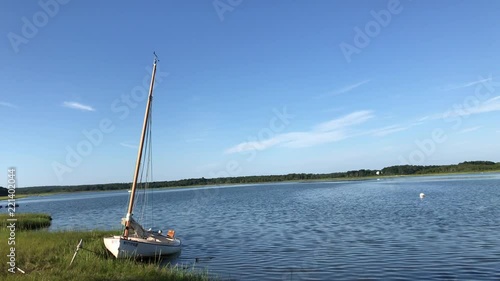 Sailboat pulled on grass marsh in accobanac harbor, Long Island photo