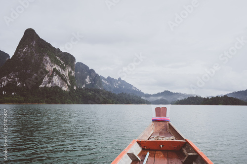 Boat tail to sail see scenic and unique landscape with floating houses and long tail boats at Chieou Laan lake, Thailand photo