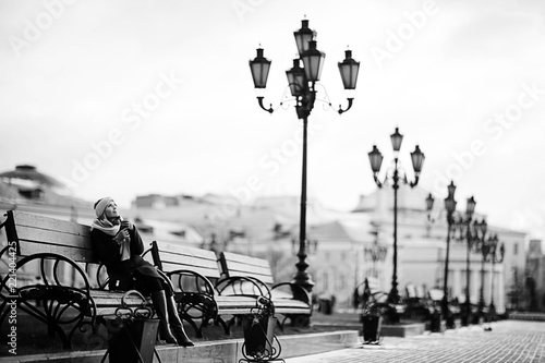 woman on a bench in a winter city © kichigin19