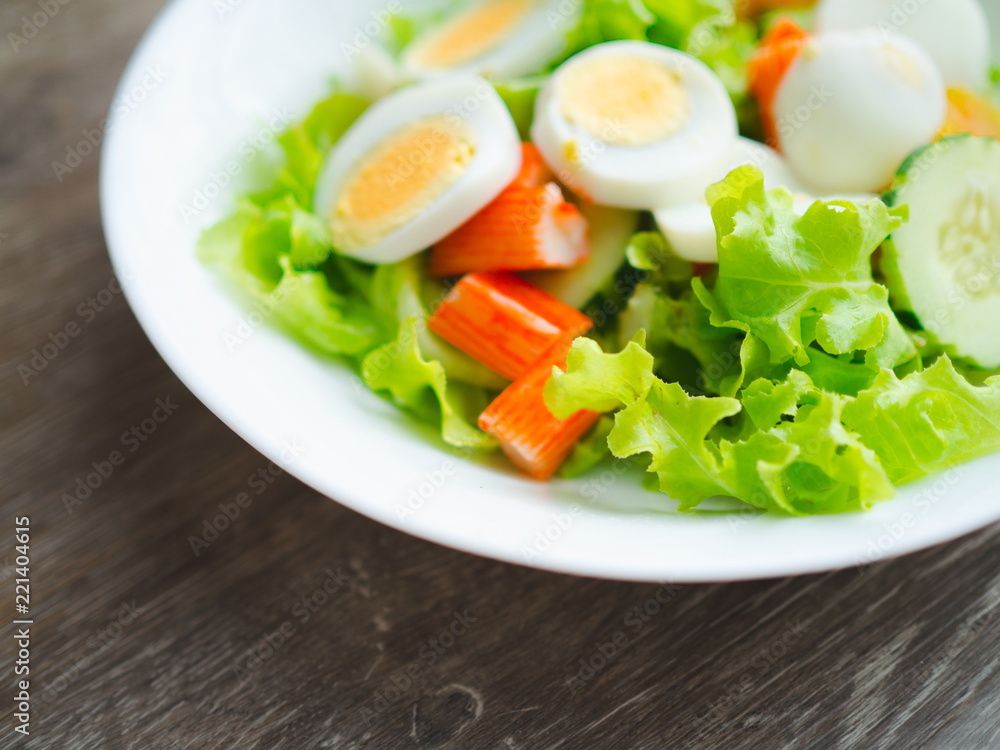 Close up healthy bowl of homemade salad with fresh vegetables, crab stick, eggs Close up healthy bowl of homemade salad with fresh vegetables, crab stick, eggs