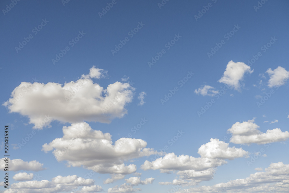 Photograph of a blue sky with beautiful white clouds on a summer afternoon with sun Photograph of a blue sky with beautiful white clouds on a summer afternoon with sun