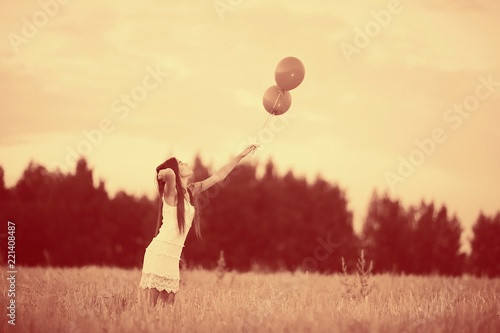 Dream, happiness - young girl in a field with flying balloons © kichigin19