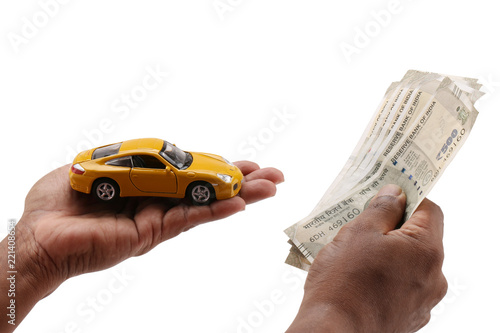 indian currency notes and toy car in the hands bank loan concept  photo