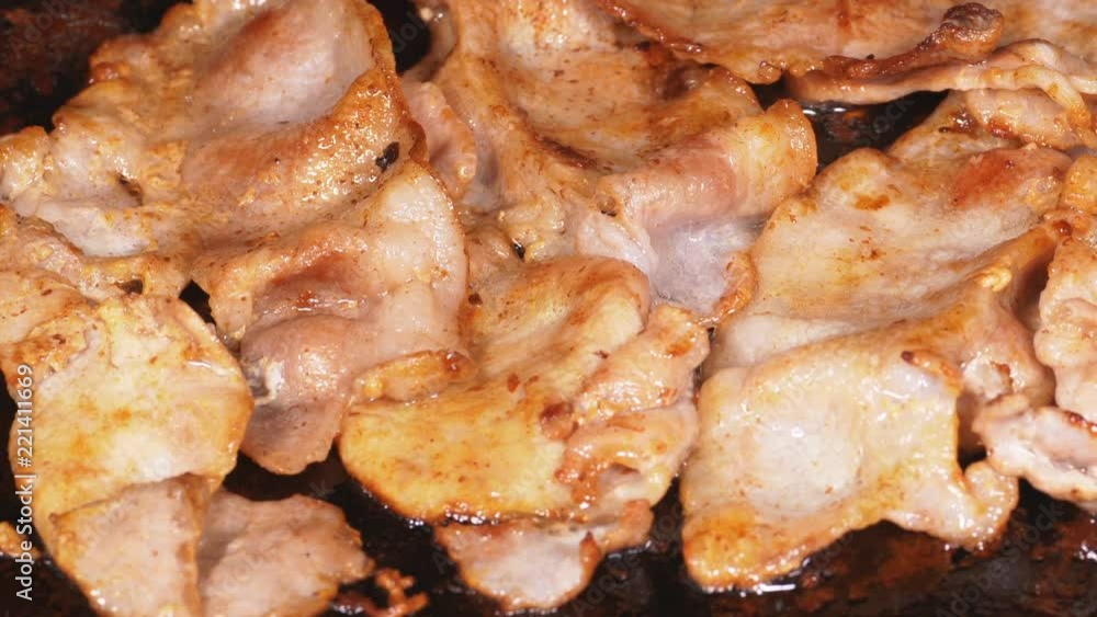 1080p dolly shot of delicious thin sliced bacon frying on the iron 1080p dolly shot of delicious thin sliced bacon frying on the iron