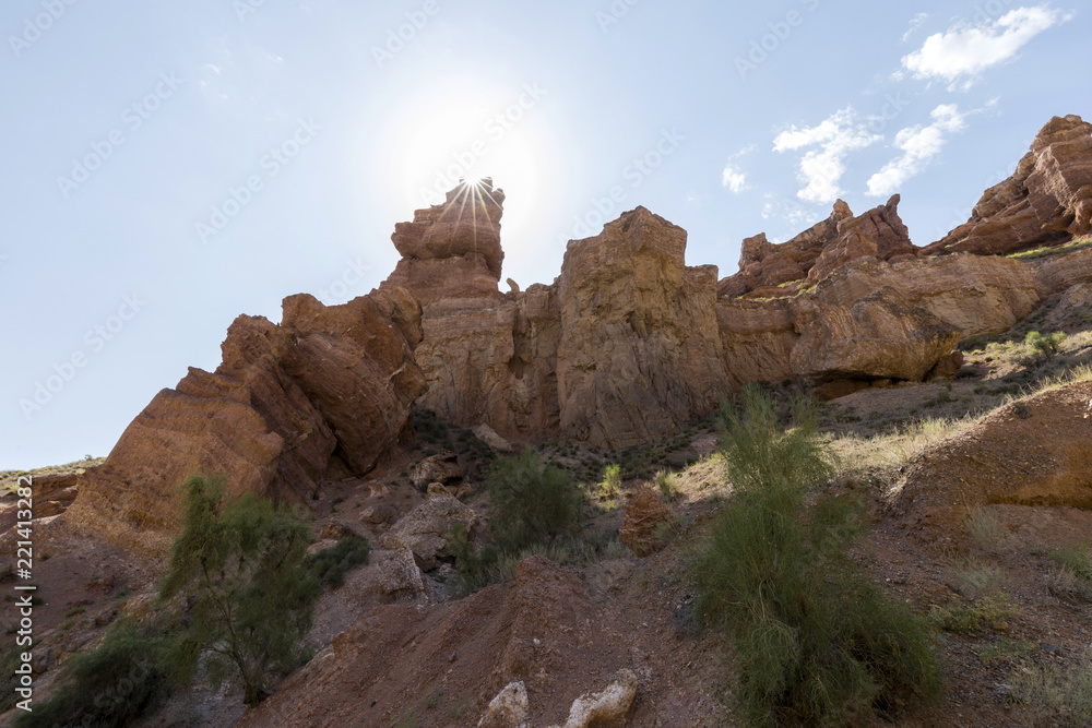 Views within the Charyn Canyon to the reddish sandstone cliffs. The canyon is also called valley of castles and is located east of Almaty in Kazakhstan.