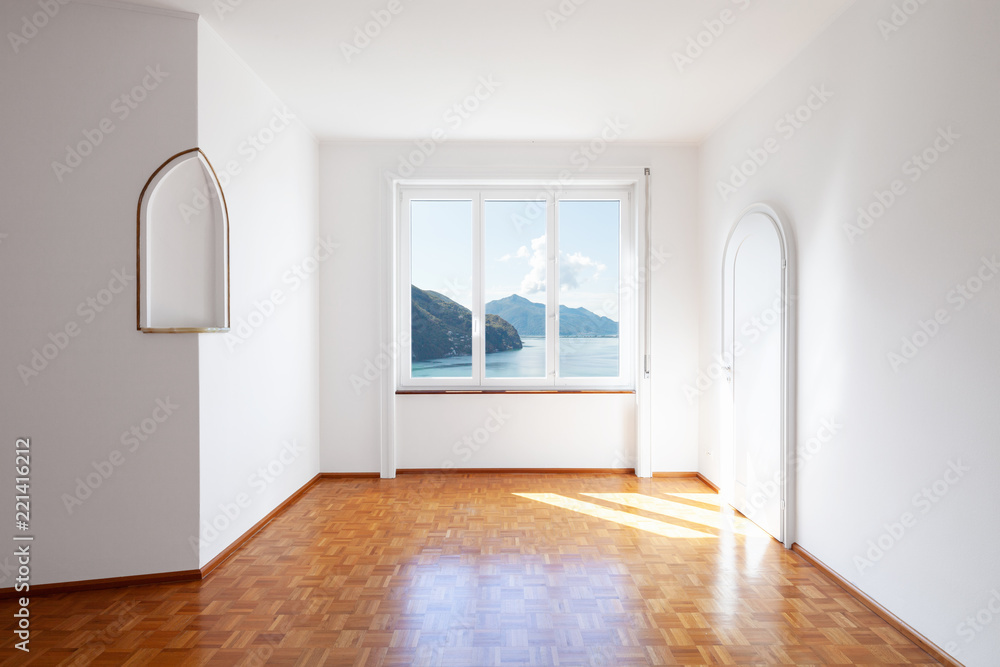 White room with large windows overlooking the lake White room with large windows overlooking the lake