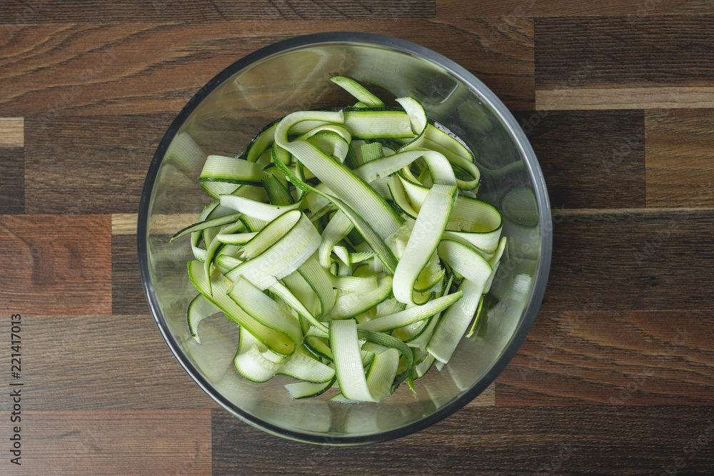 Fresh zucchini slices in glass bowl for cooking vegetables diet salad. Healthy food concept Fresh zucchini slices in glass bowl for cooking vegetables diet salad. Healthy food concept