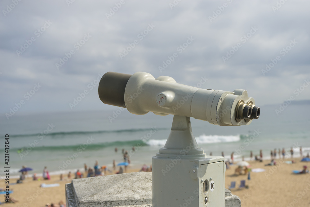 Coin operated binocular on the summer beach, tourist scene in Spain Coin operated binocular on the summer beach, tourist scene in Spain