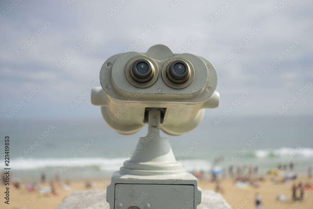 Coin operated binocular on the summer beach, tourist scene in Spain Coin operated binocular on the summer beach, tourist scene in Spain