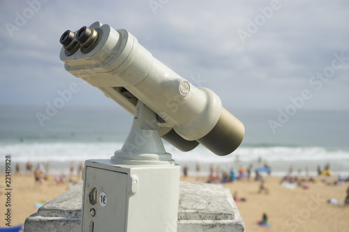 Coin operated binocular on the summer beach, tourist scene in Spain