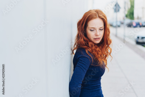 Thoughtful sad young woman with downcast eyes