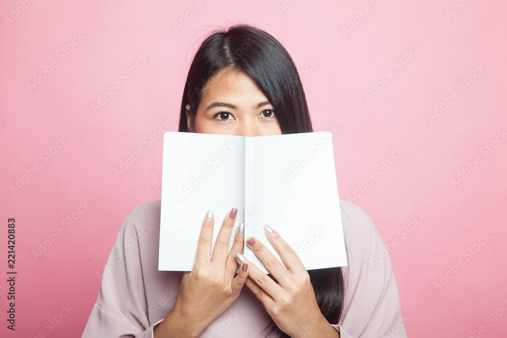 Young Asian woman with a book. Young Asian woman with a book.