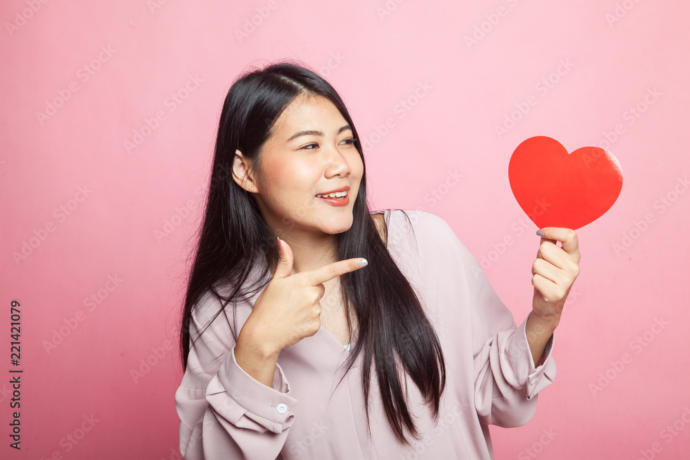 Asian woman point to red heart. Asian woman point to red heart.