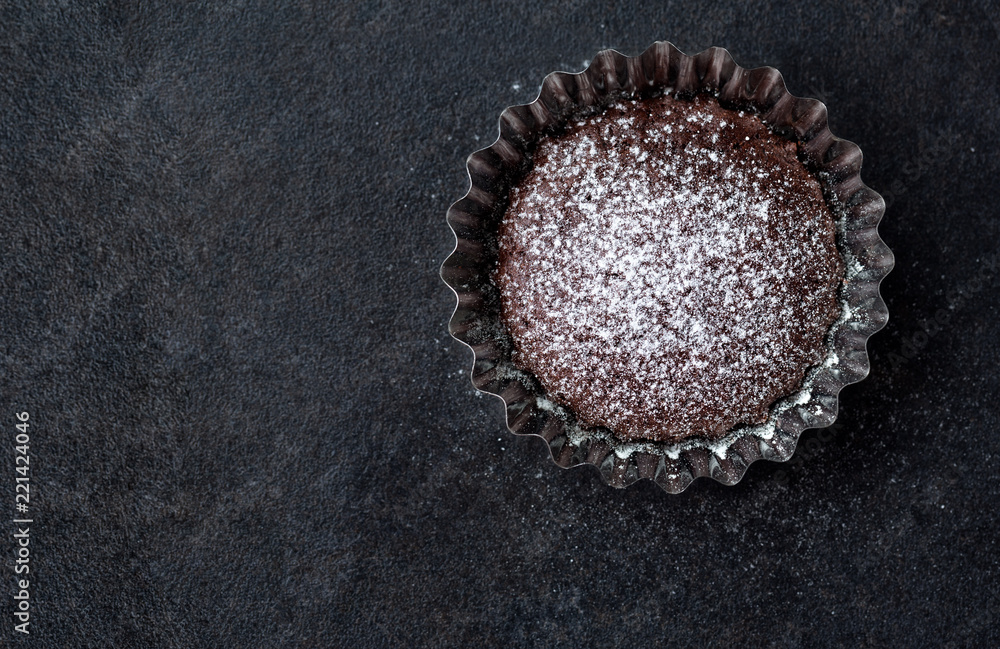 fresh chocolate muffin with powdered sugar. fresh chocolate muffin with powdered sugar.