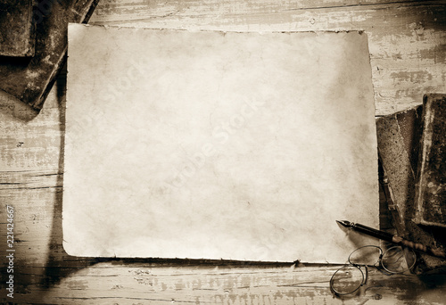 old parchment on antique writing desk,sepia image photo
