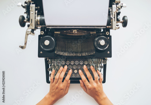 Writer typing with retro typewriter, high angle view photo