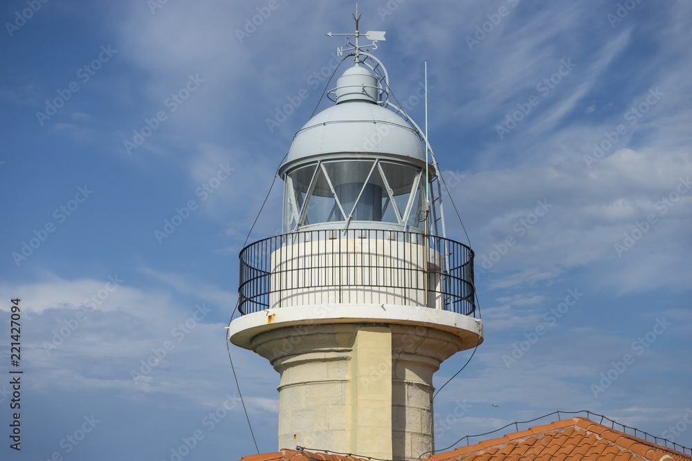 Summer, coastal lighthouse on the Playa de los Locos in Cantabria, Spain