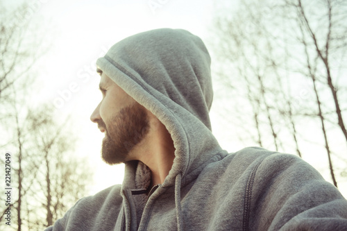 cheerful man with smile, bearded guy looks at the camera and laughs, a bright spring smile of a man