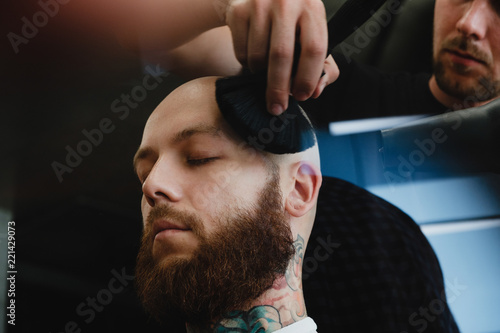 Slika na platnu Bearded skinhead man in barbershop