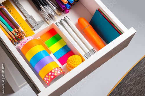 Opened office desk drawer with stationary photo