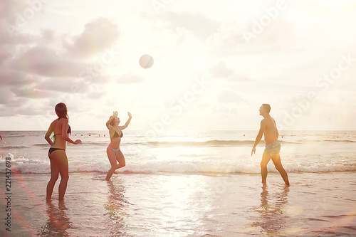 silhouettes of athletes running along the beach / sports summer in the warm sea, healthy rest, sports activity, summer vacation