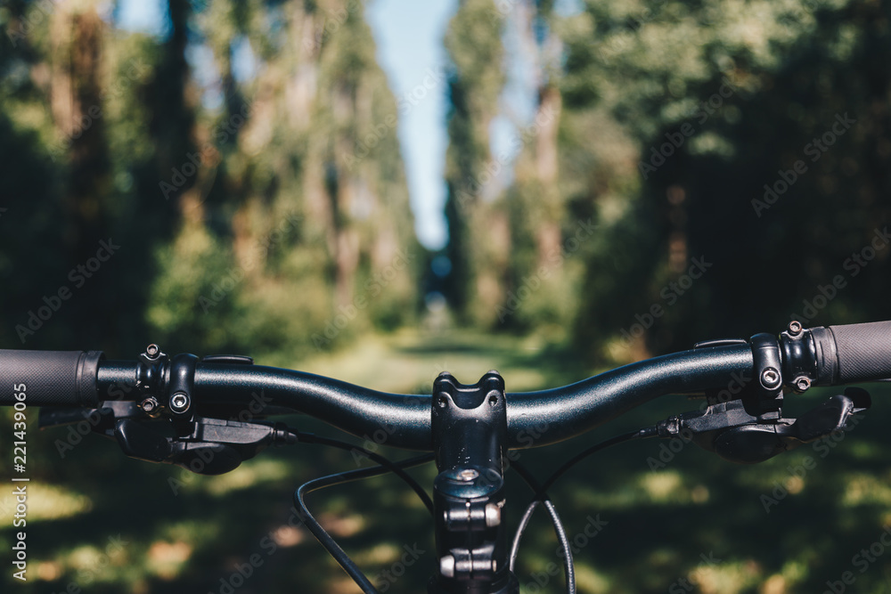 Mountain bike handlebar stem in the park. Point of view Mountain bike handlebar stem in the park. Point of view
