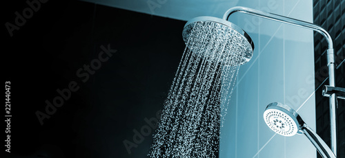 Close up of Water flowing from shower in the bathroom interior photo