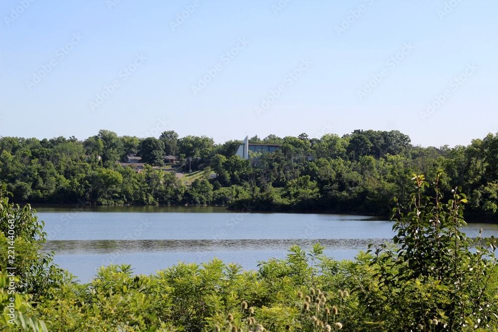 A view of the lake and the hill landscape over the bush.