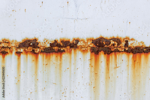 Corrosion of welding seam with red stains on a old white metal sheet. Abstrac...