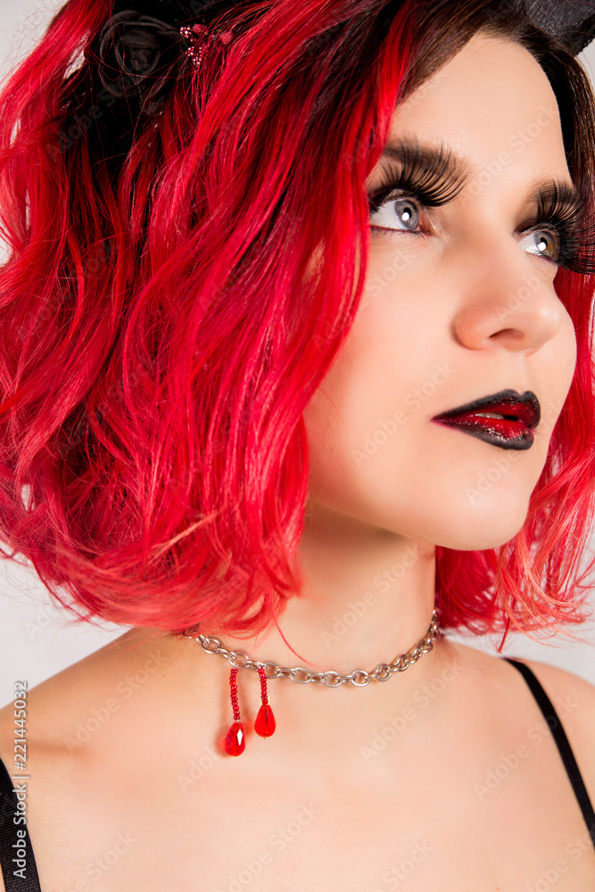 Fototapeta premium Red-haired model with horns. Halloween