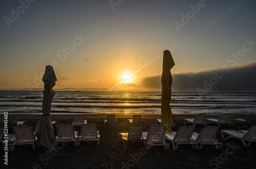 Sunbeds on the beach of Black Sea at sunrise, warm moments