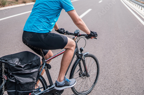 Man riding a bike on an empty highway