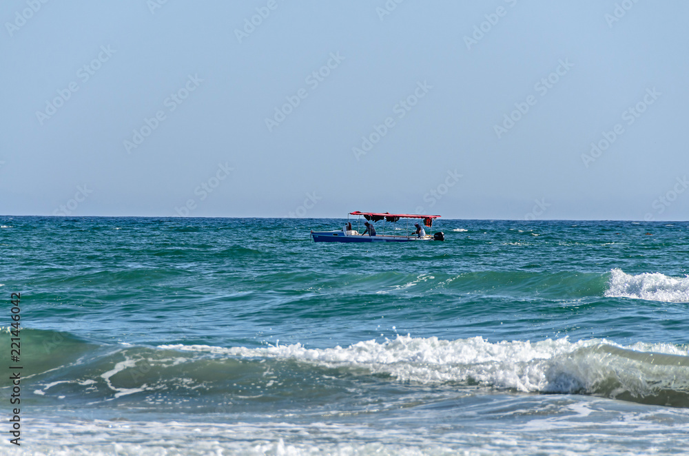 Boat near the Beach of Black Sea from Mamaia, Romania, blue clear water