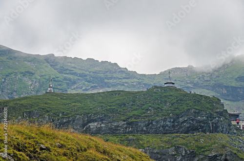 The Transfagarasan road in Fagaras mountains, Carpathians with green grass and rocks, peaks in the clouds