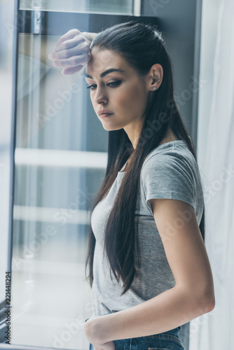 depressive young brunette woman leaning at window and looking away Free Download depressive young brunette woman leaning at window and looking away - GFXLoad