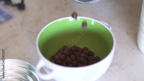 Pouring the cereal into the bowl photo