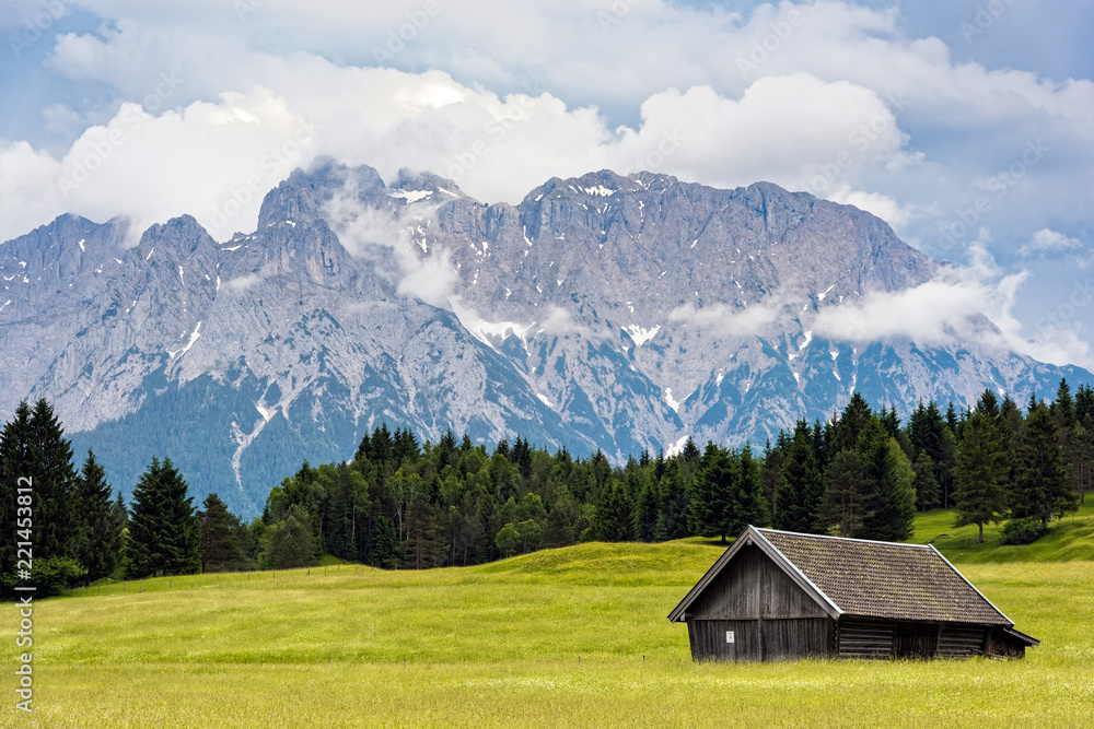 Wooden hut near Zugspitze, the highest mountain of Germany at the Bavarian Alps