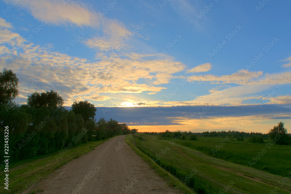 Country road at sunset in summer. Kostroma, Russia. Country road at sunset in summer. Kostroma, Russia.