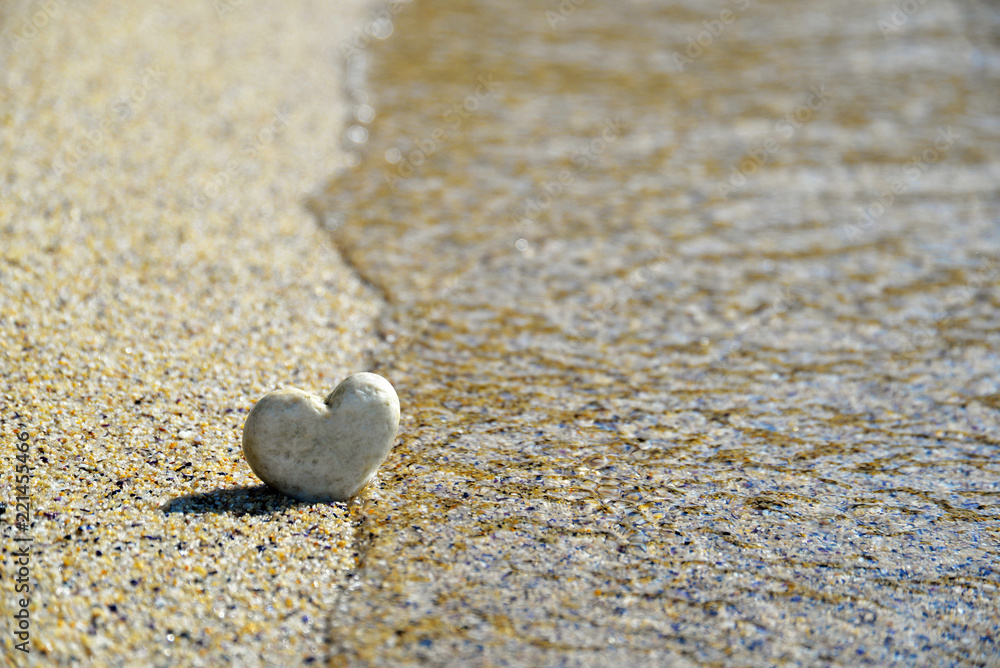 Heart stone in the sand, holiday background Heart stone in the sand, holiday background