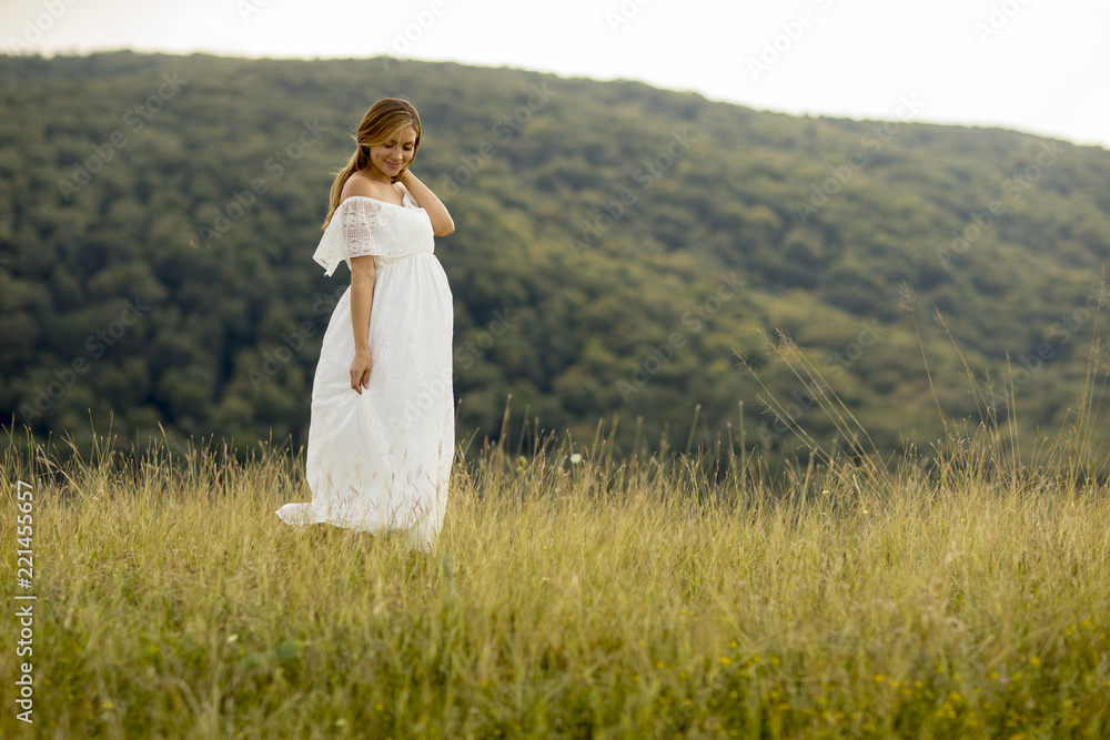 Young pregnant woman relaxing outside in nature Young pregnant woman relaxing outside in nature