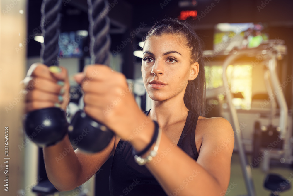 Tricep Rope Pulldown exercise during workout in gym Tricep Rope Pulldown exercise during workout in gym