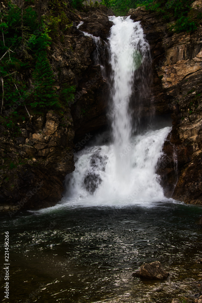 Running Eagle Falls in Glacier Nation Park.  Running Eagle Falls is named after a female warrior of the Amskapi-Pikuni Native American people.  This is a double water fall with both falls flowing in t