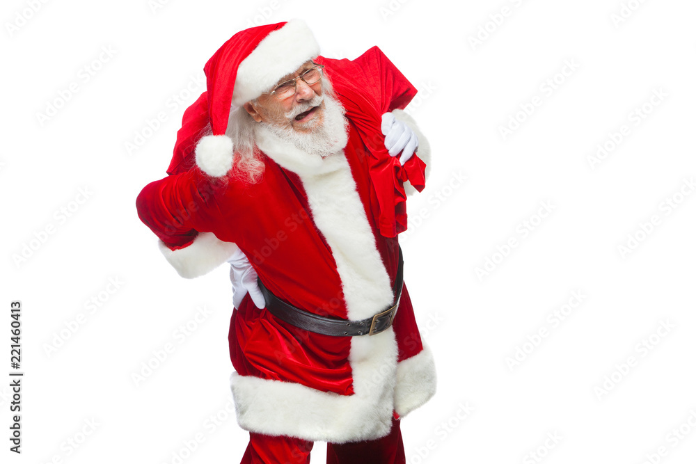 Christmas. Santa Claus is suffering from back pain and holds a red bag with gifts on his back. Isolated on white background. Christmas. Santa Claus is suffering from back pain and holds a red bag with gifts on his back. Isolated on white background.