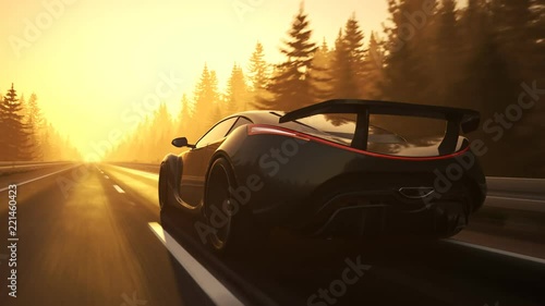 Fast, slick supercar driving through a coniferous forest during sunset. 4K HD photo